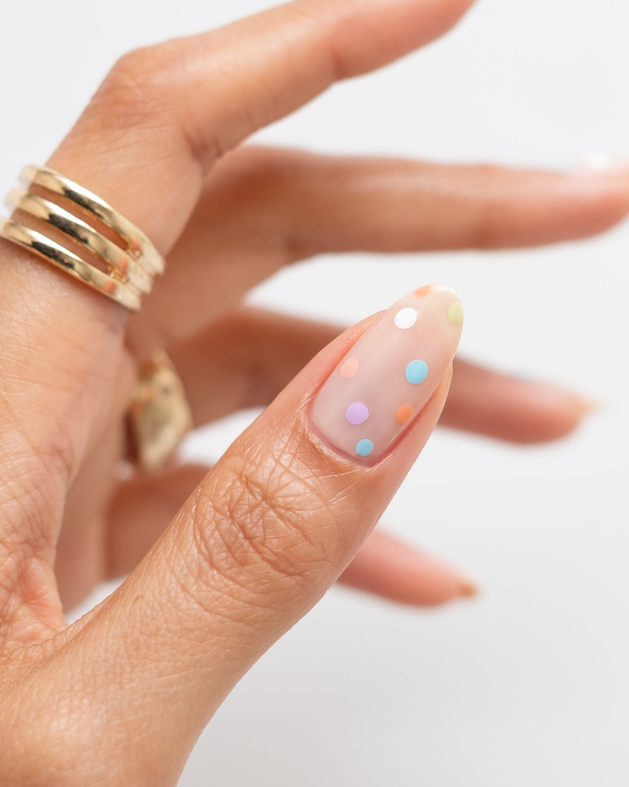 closeup of a polka dot manicured thumb 