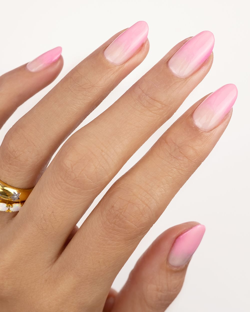 hand with pink gradient nails for valentines day nail ideas