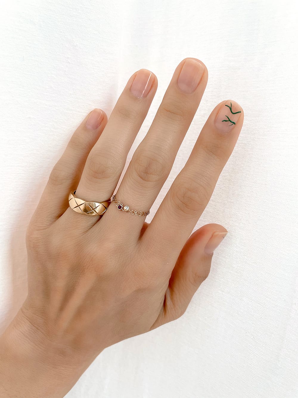 start of leaf design on nail tutorial on pointer finger