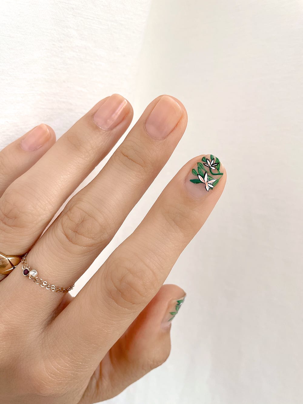 orange accents added to daisy design on index finger and thumb