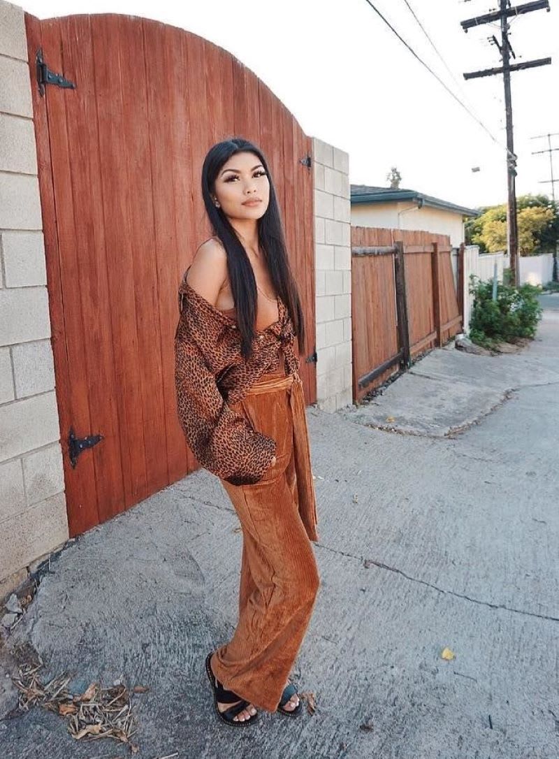 woman wearing off the shoulder top and velvet pants
