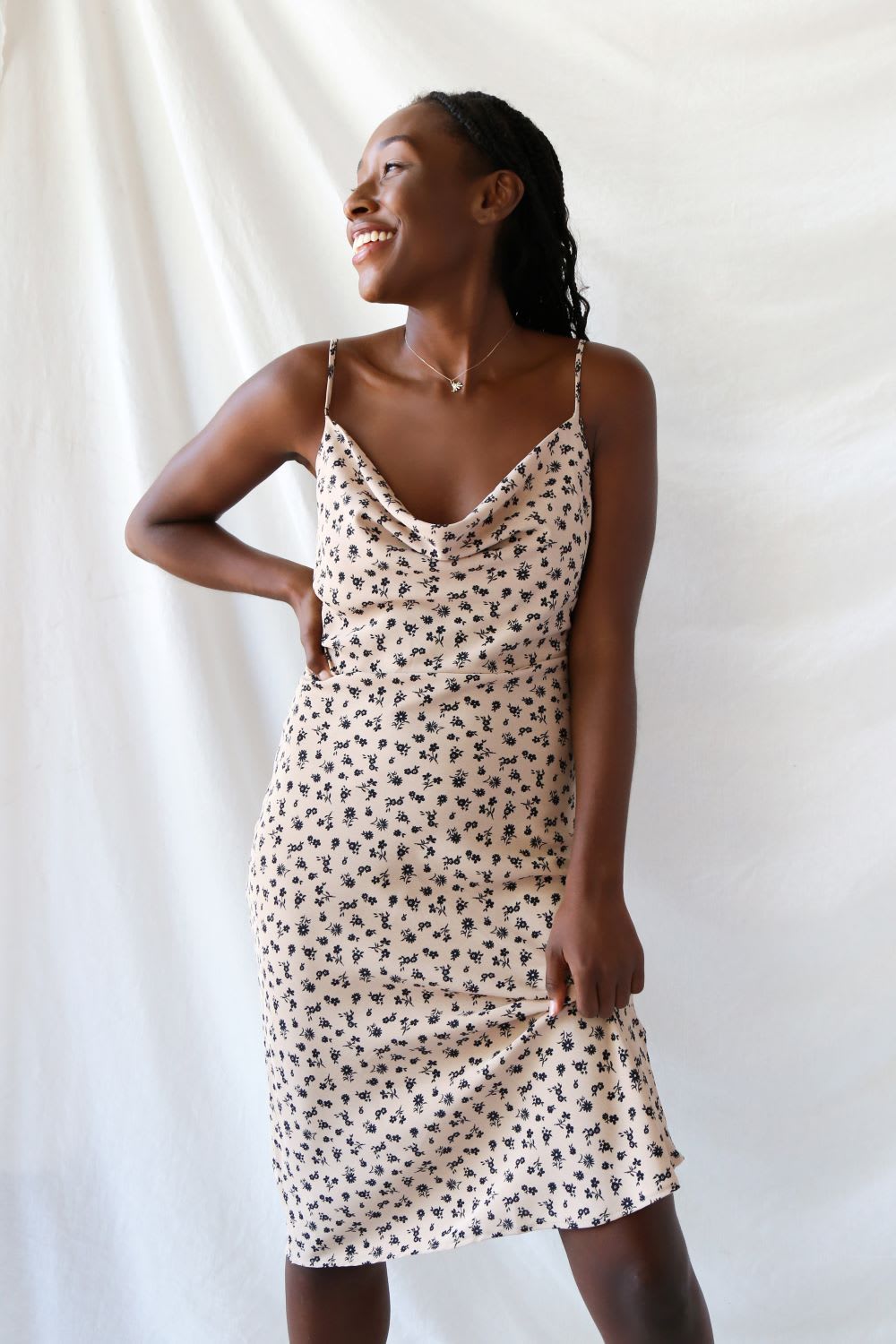 woman wearing a tan floral slip dress