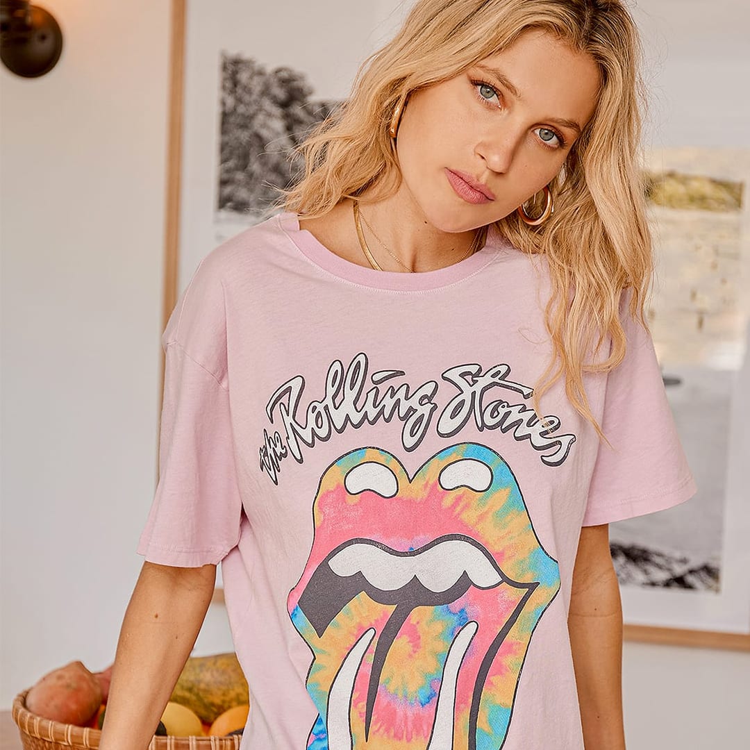 a model wearing a pink tie dye rolling stones graphic tee