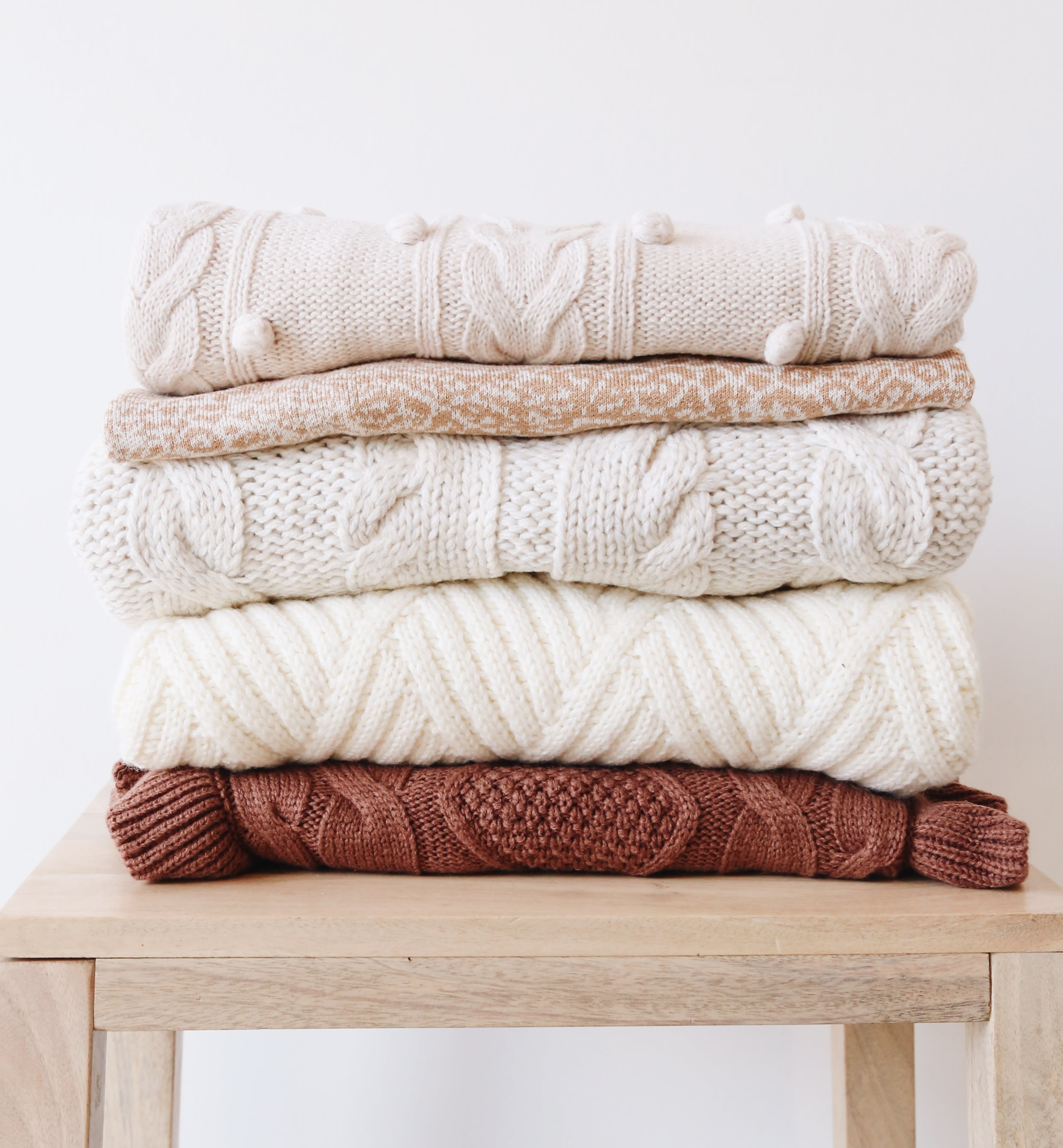 folded pile of sweaters organized