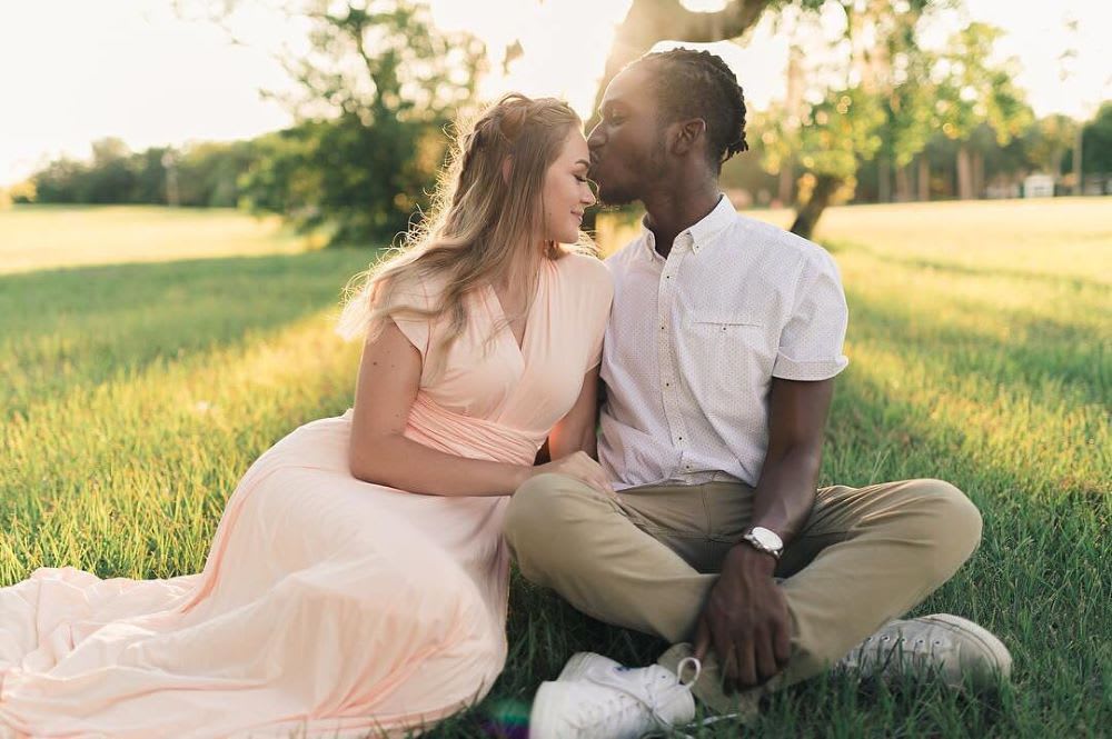 couple sitting on the grass for an affordable unique valentines day idea
