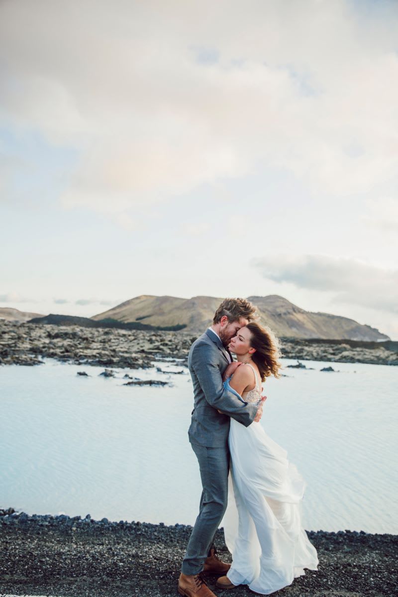 couple hugging by the water
