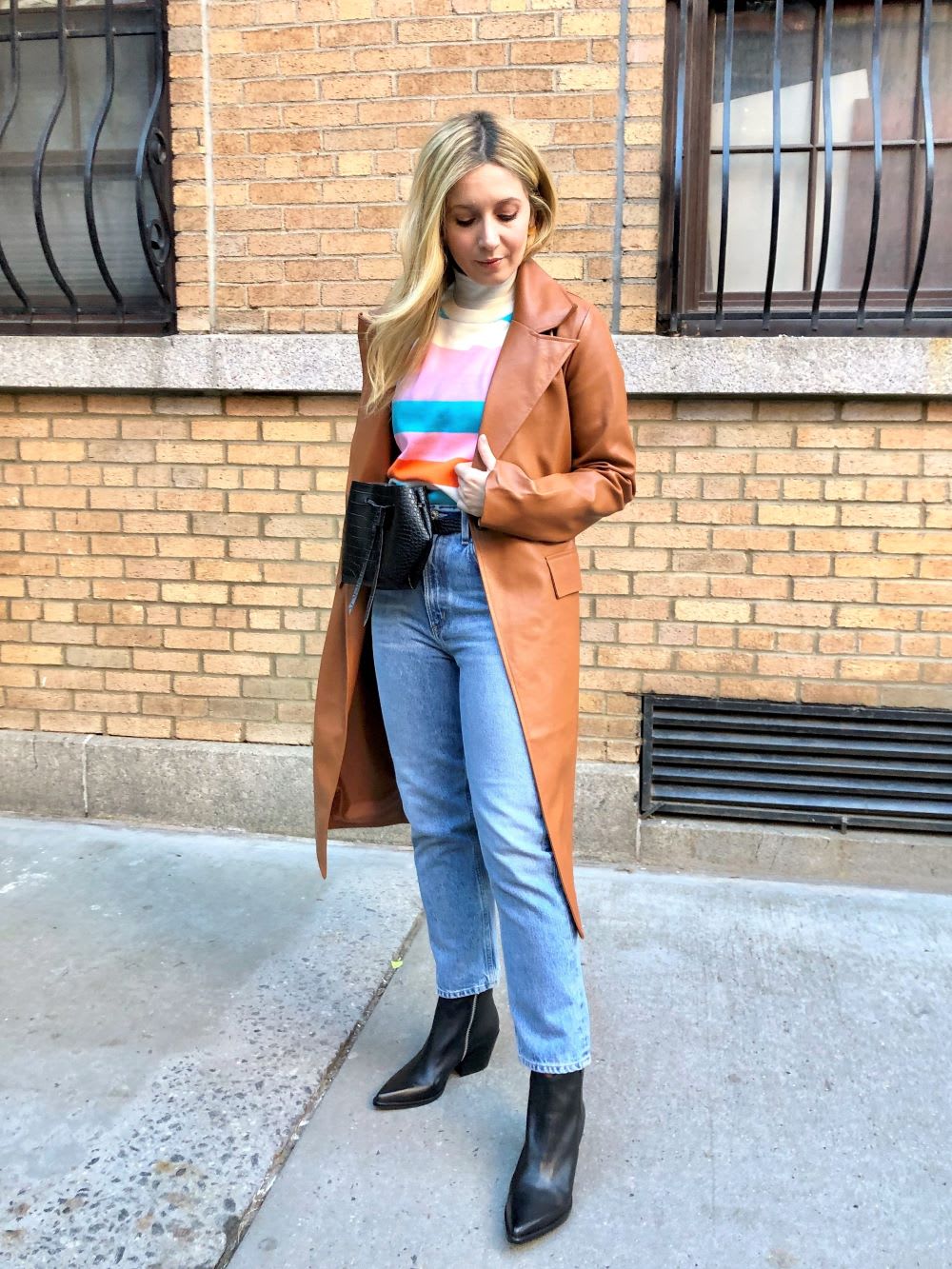 leather trench coat over striped sweater and jeans - how to layer for winter fashionably