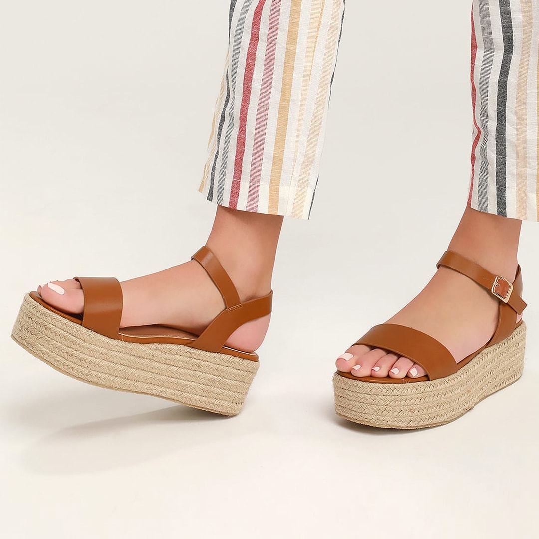legs in multicolor striped pants with tan espadrille flatform sandals on feet