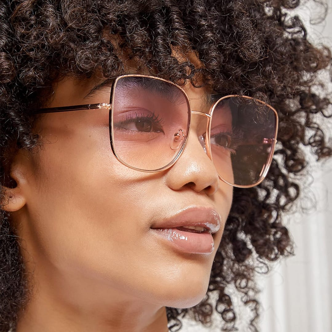 a model wearing rose gold oversized sunglasses
