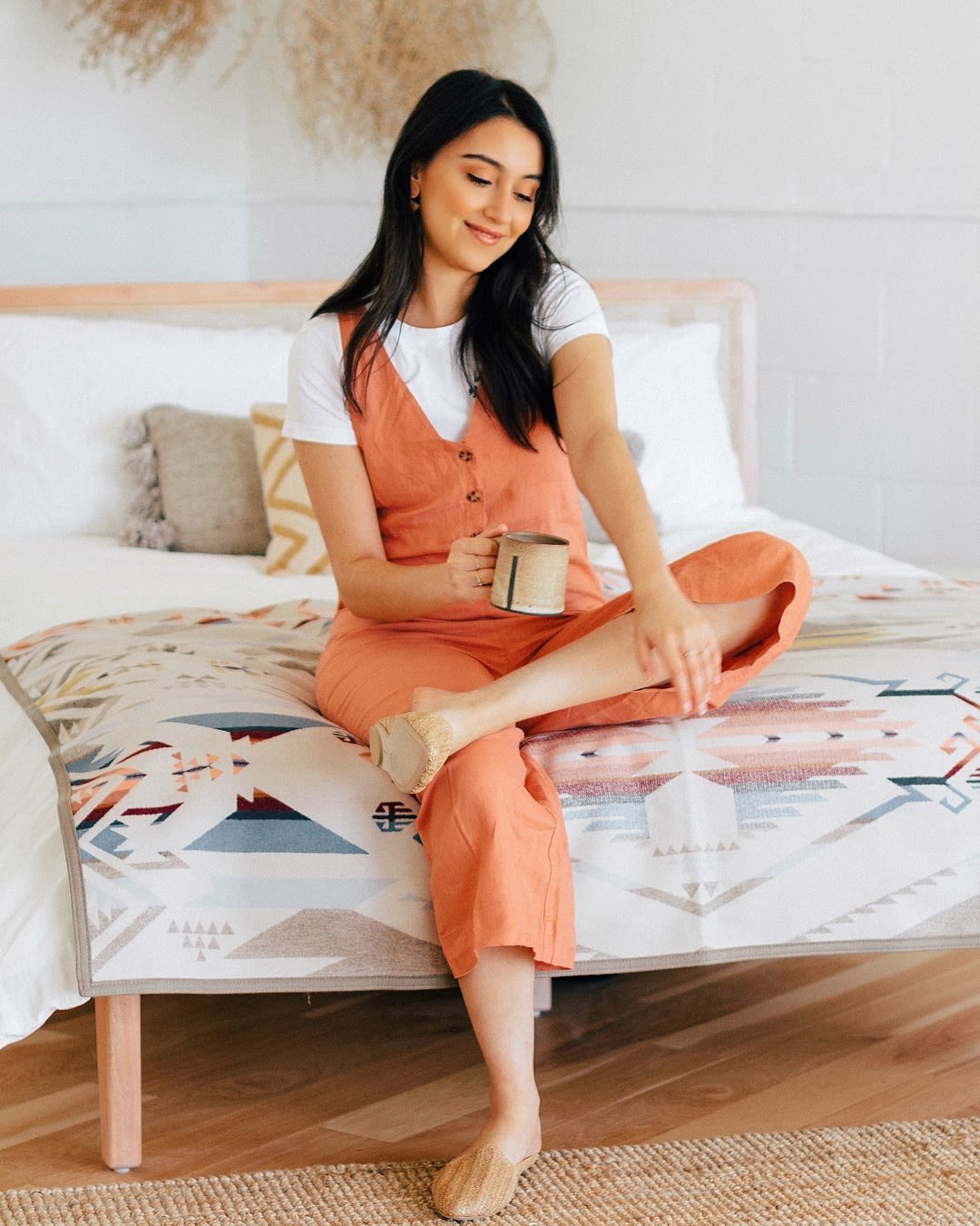 woman sipping cup in bed - best morning routine, upgrade your morning routine
