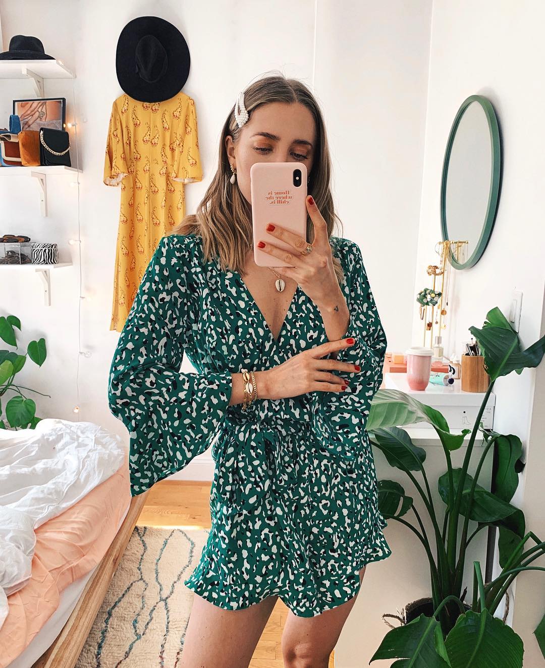 woman with hair clip taking photo in the mirror- - best morning routine, upgrade your morning routine