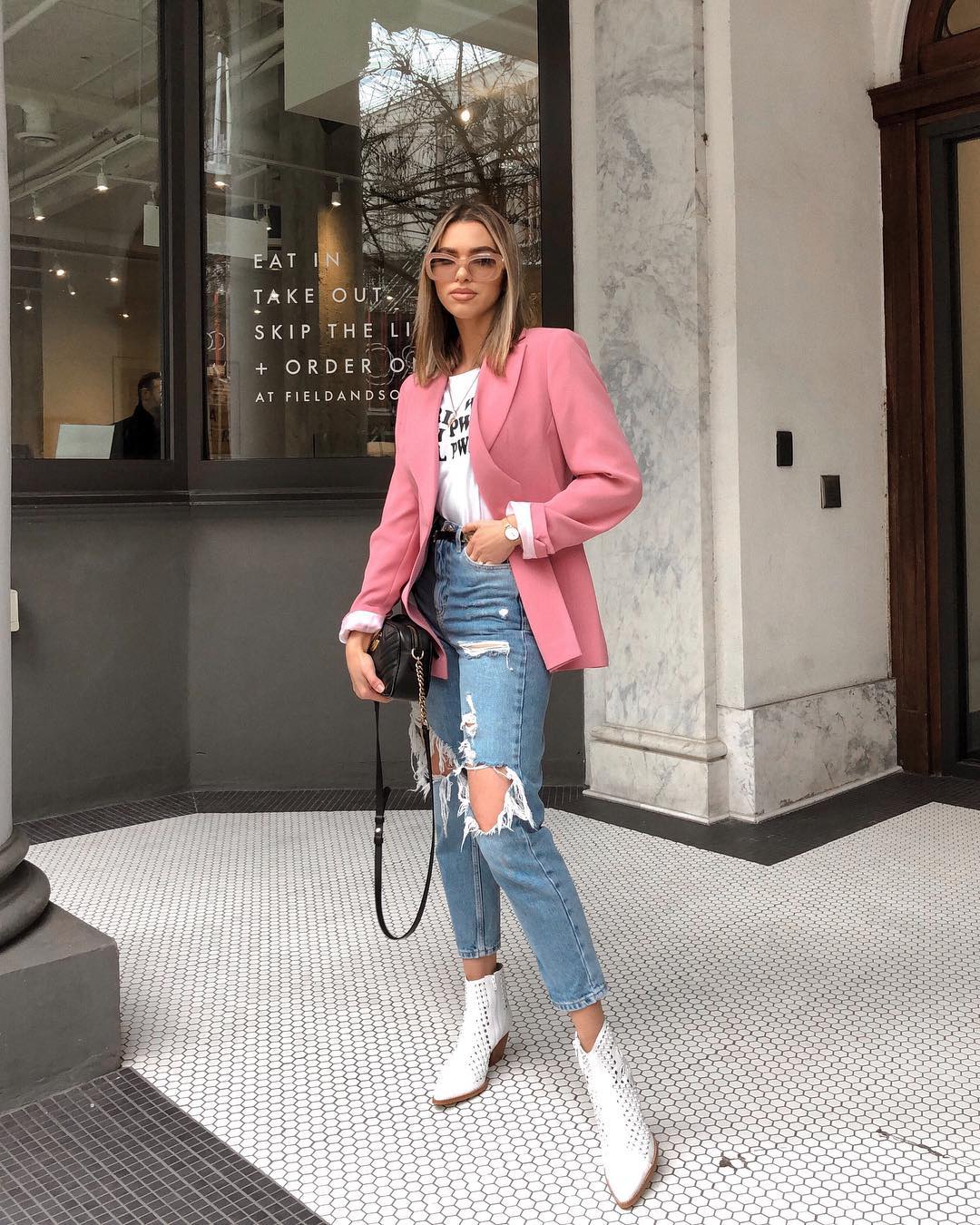 spring outfit ideas - pink blazer + distressed jeans + white boots + graphic tee