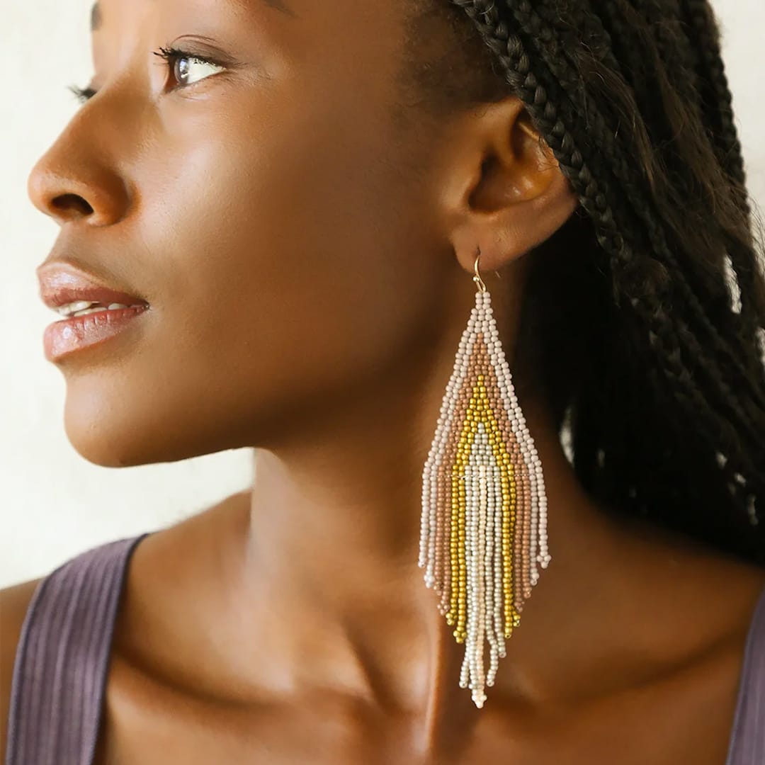 lavender multi beaded fringe earrings on a model