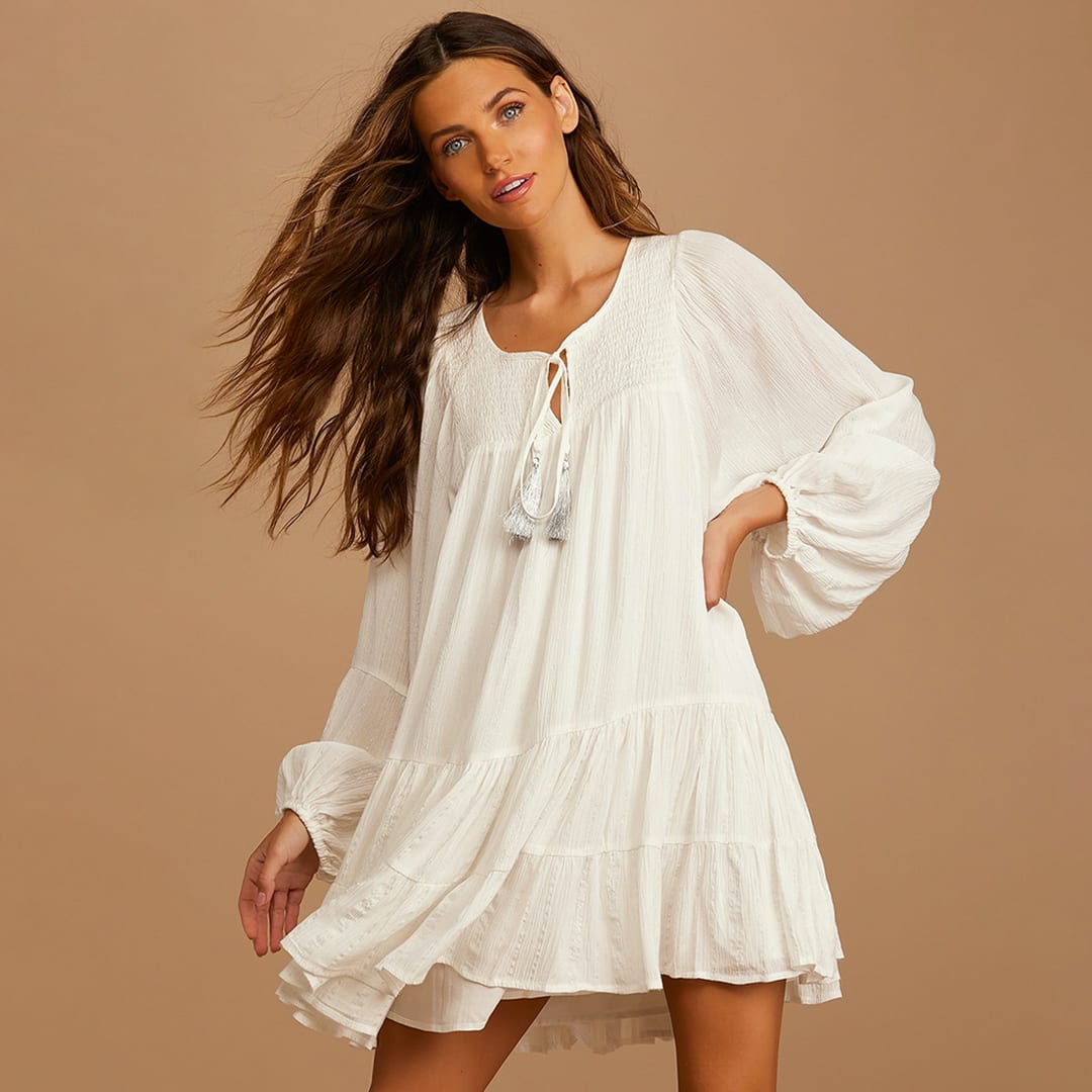 model wearing a white tiered long sleeve boho swing dress