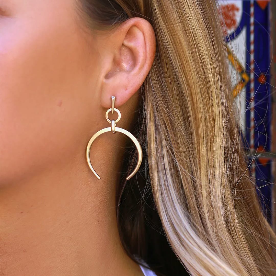 close up of gold boho earrings