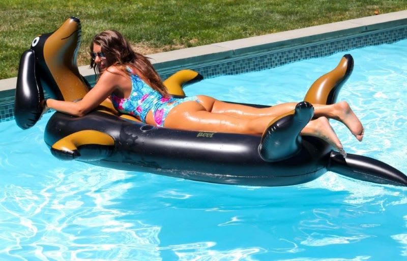 woman laying on an inflatable dog pool float for adults