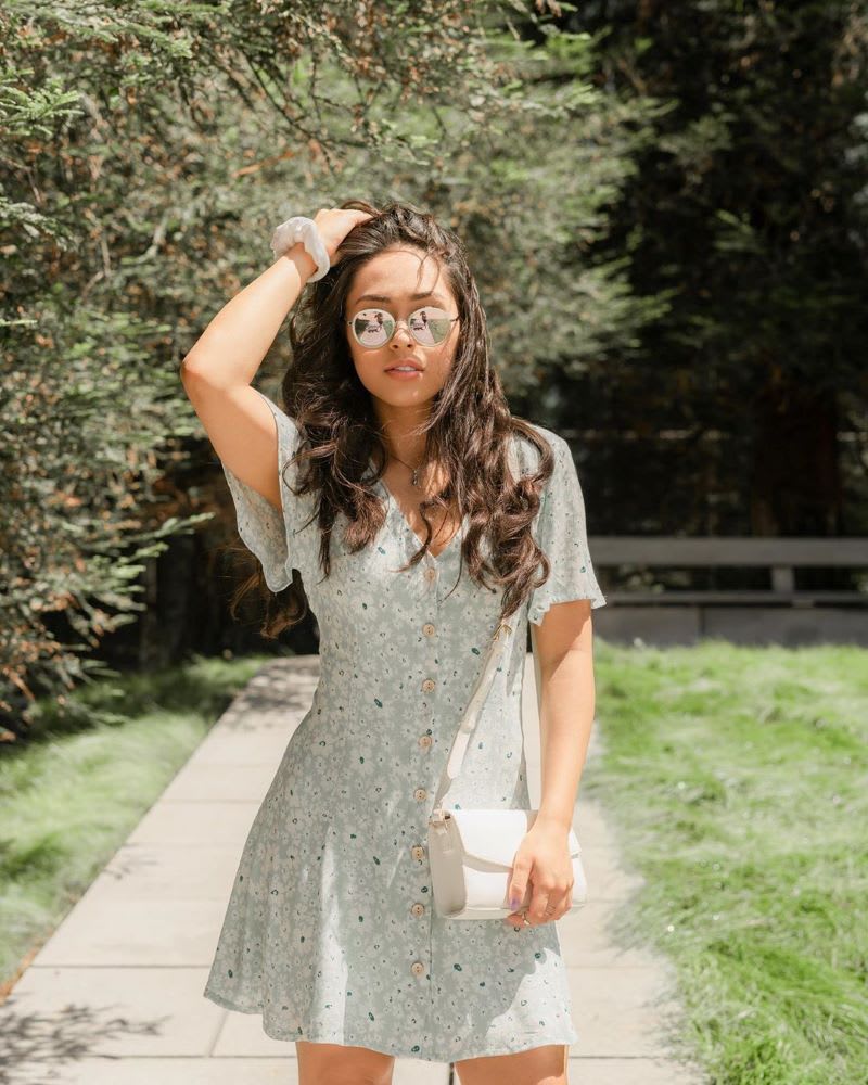 Woman in sunglasses and mint floral mini dress 