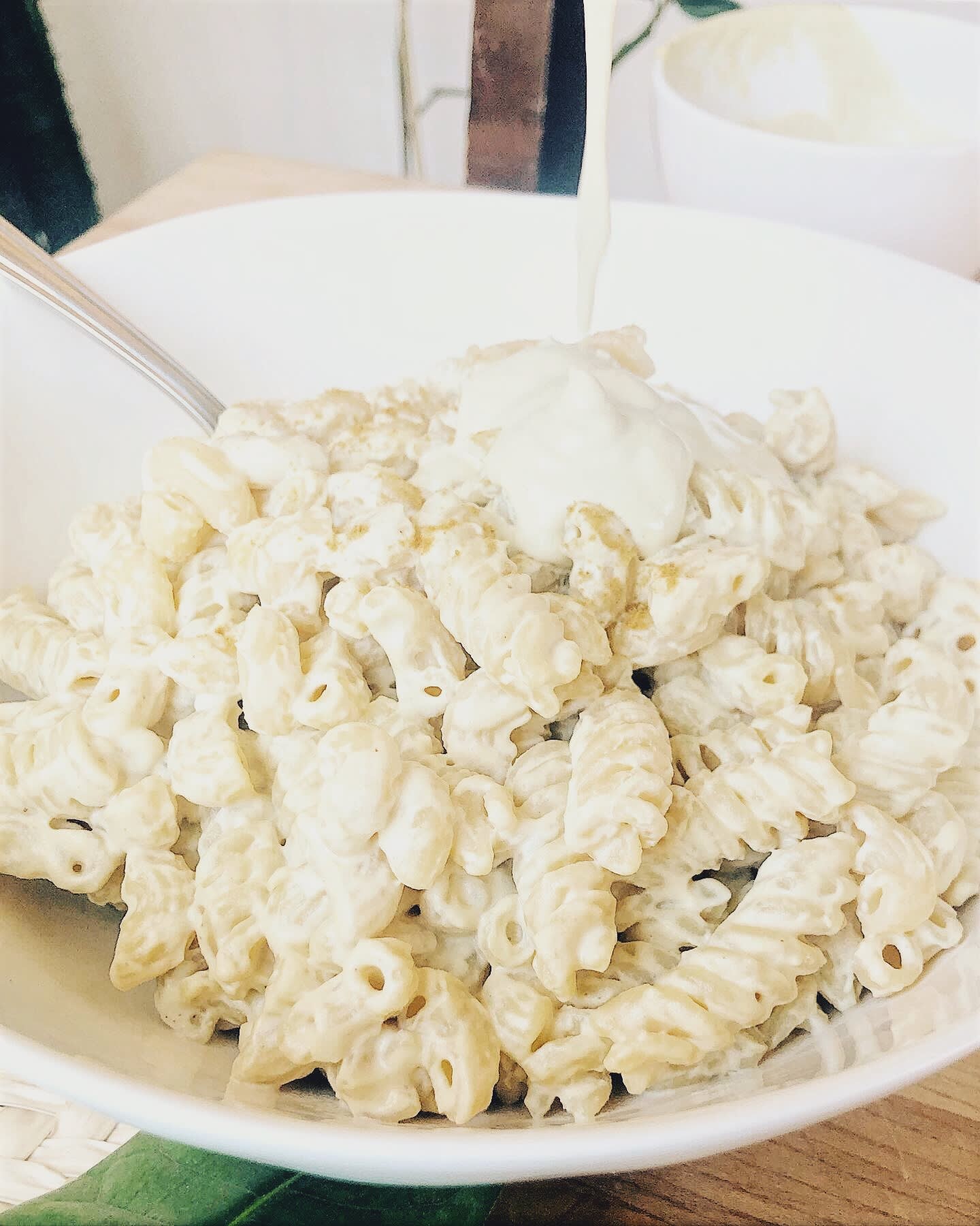 creamy white vegan mac and cheese in white bowl