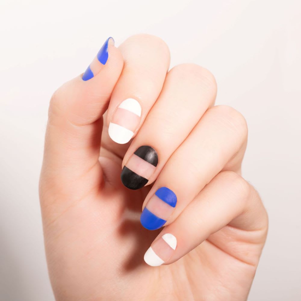 negative space manicure with blue white and black nail polish