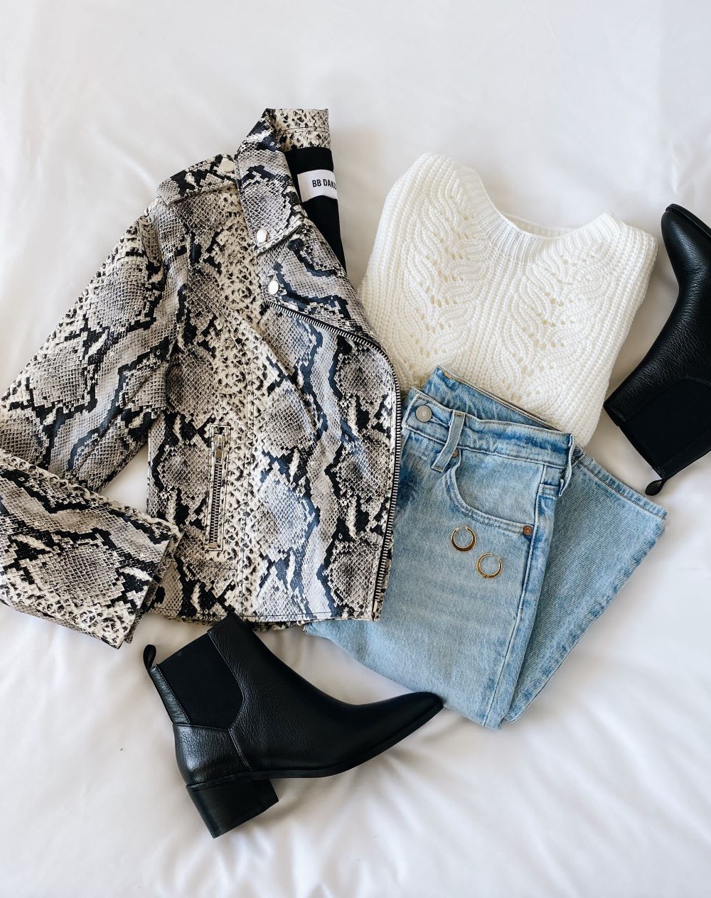 snake print vegan leather jacket with black ankle boots and jeans and white sweater