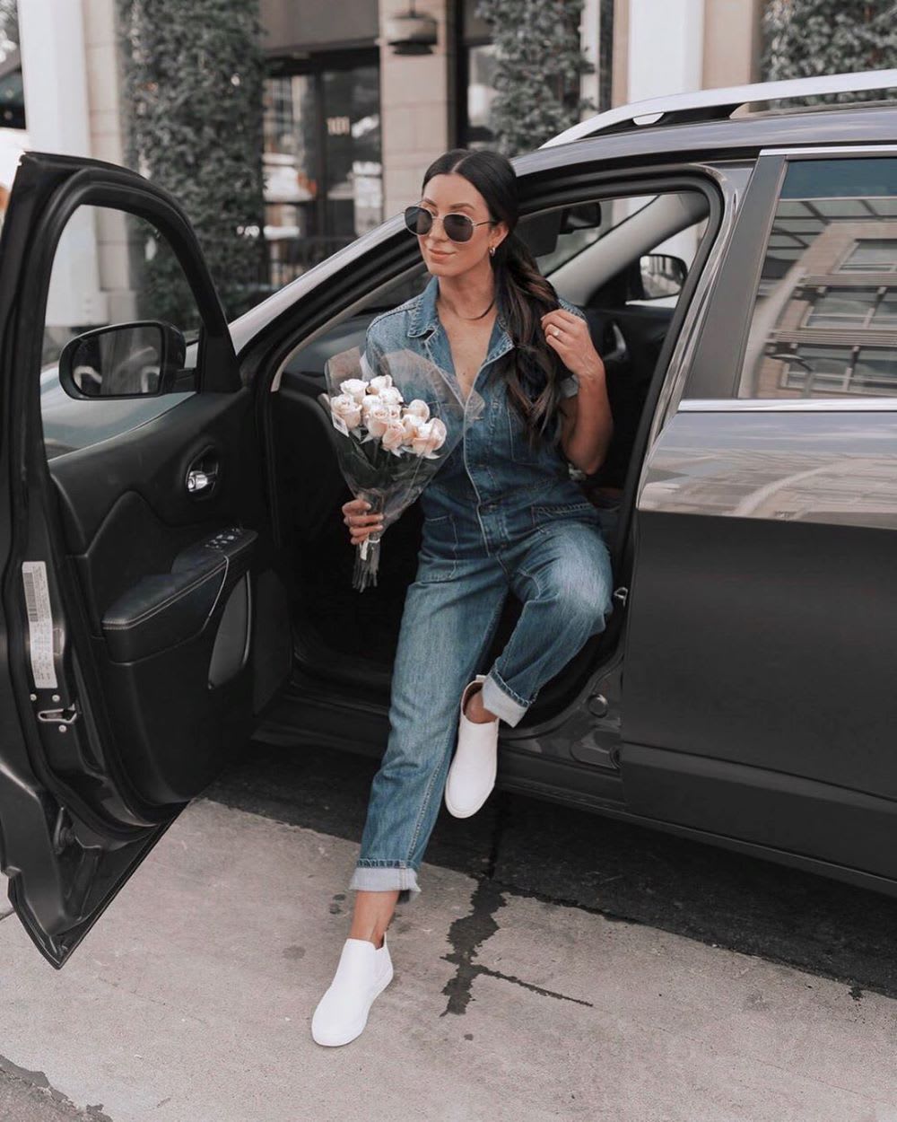 woman in denim boiler suit with roses