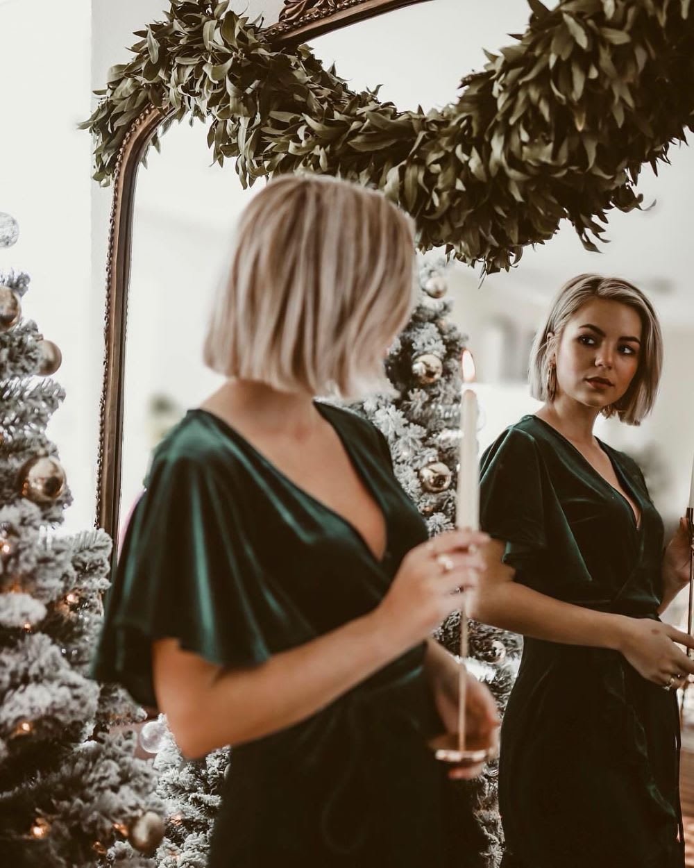 woman in mirror with holiday decorations for christmas on a budget