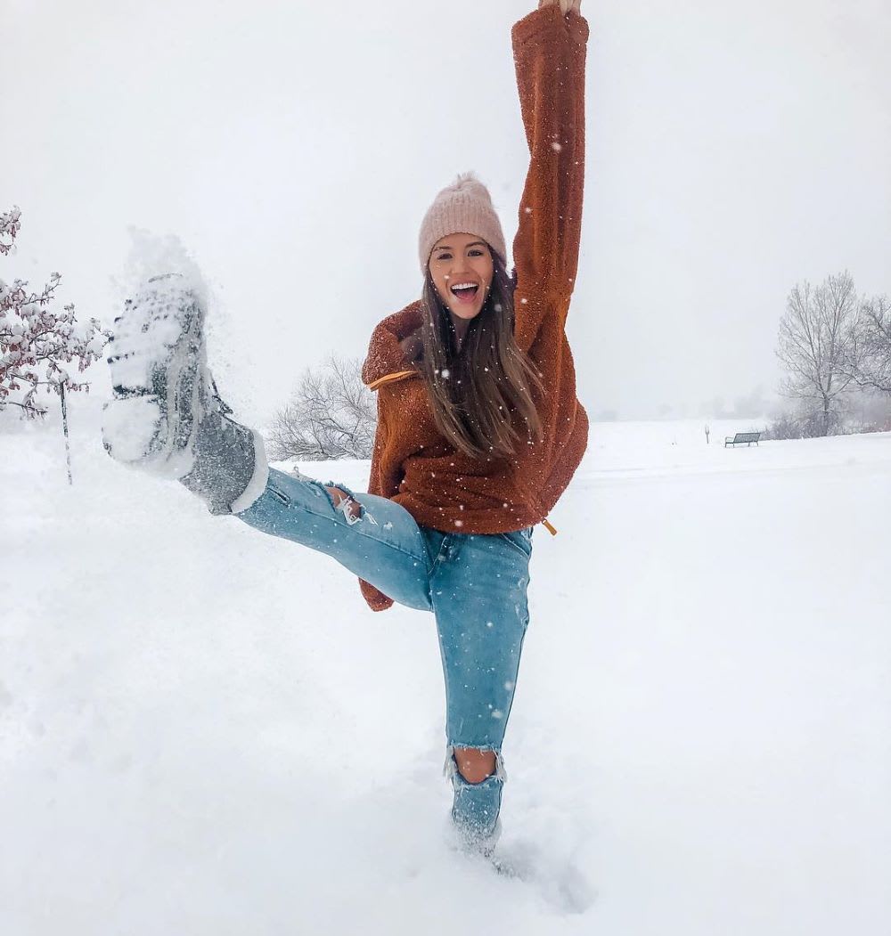 holiday budgeting: woman having free fun in the snow