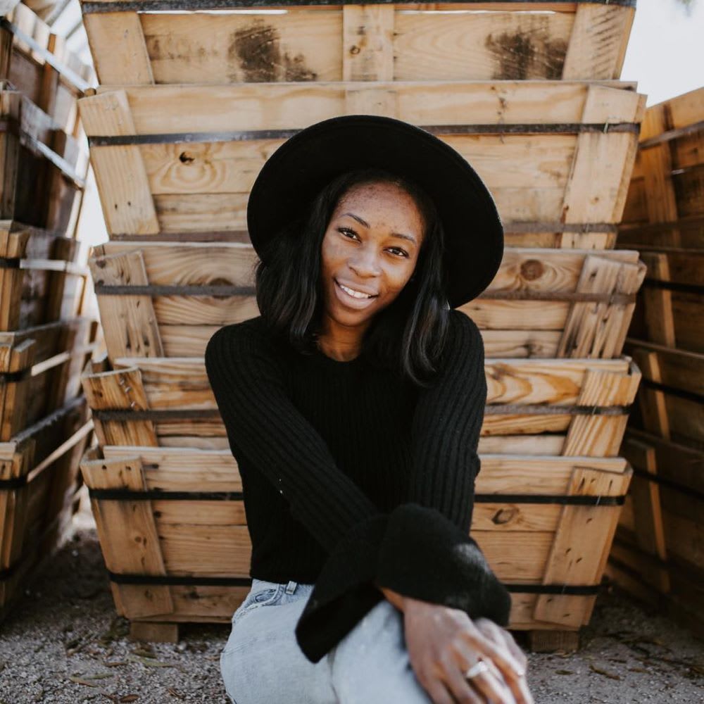 woman wearing a black top and black hat