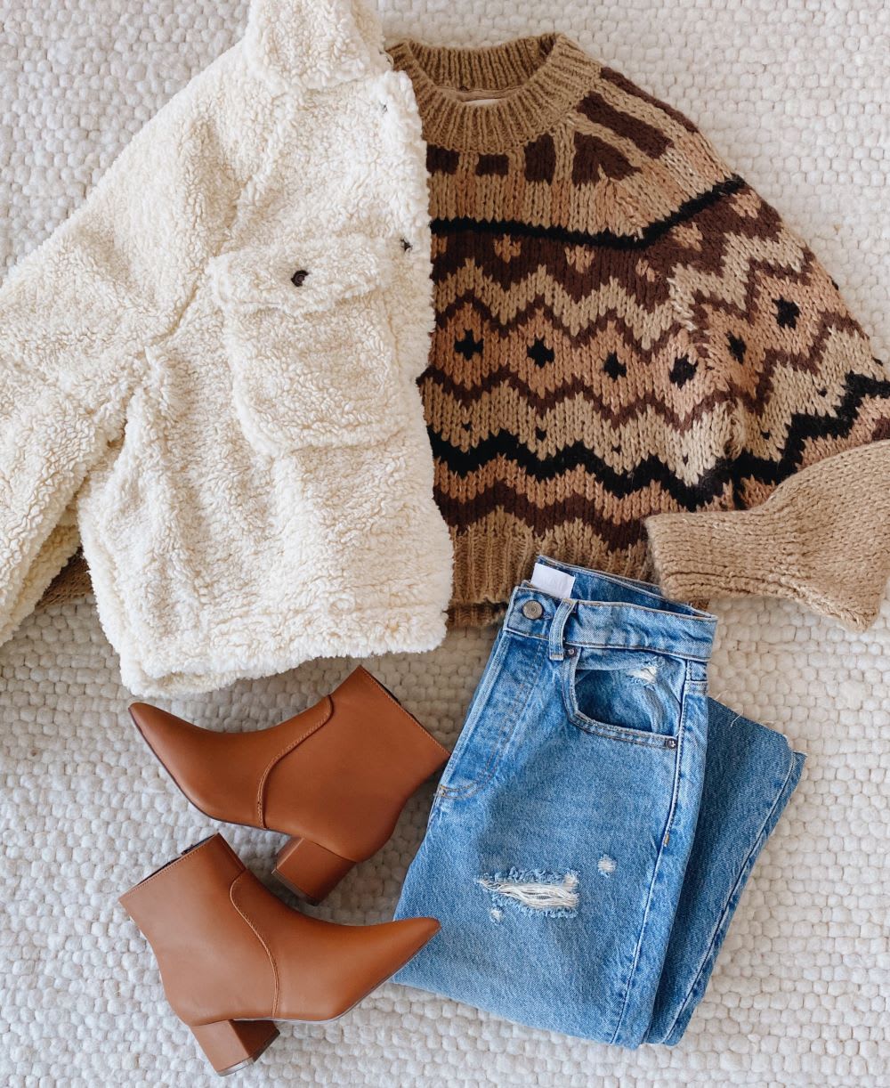 cream women's teddy jacket with print sweater, jeans, and brown ankle boots