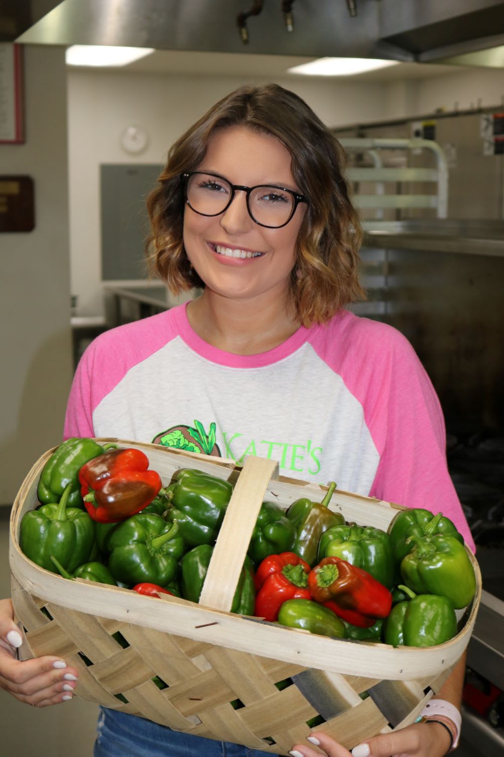 katie stagliano with vegetables to help food insecurity