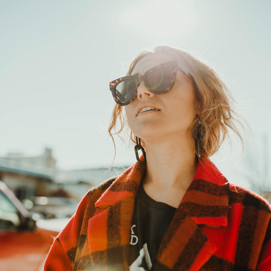 woman looking at the sky with sunglasses
