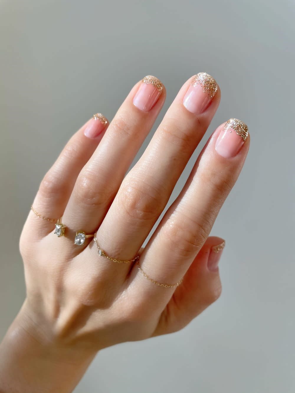 nude nails with gold glitter tips