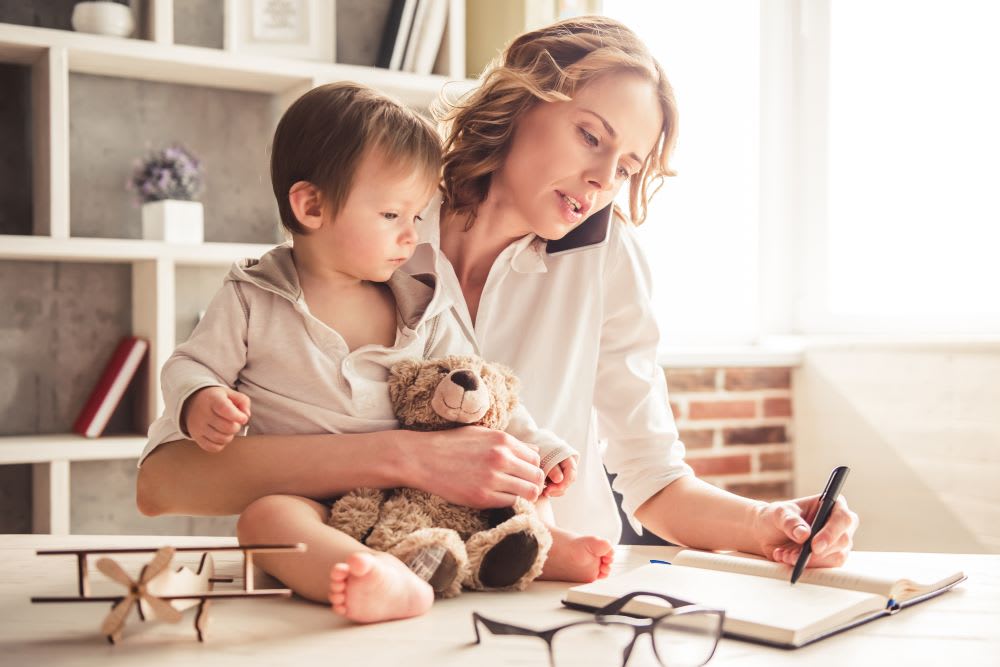 working mom at computer: divorce tips
