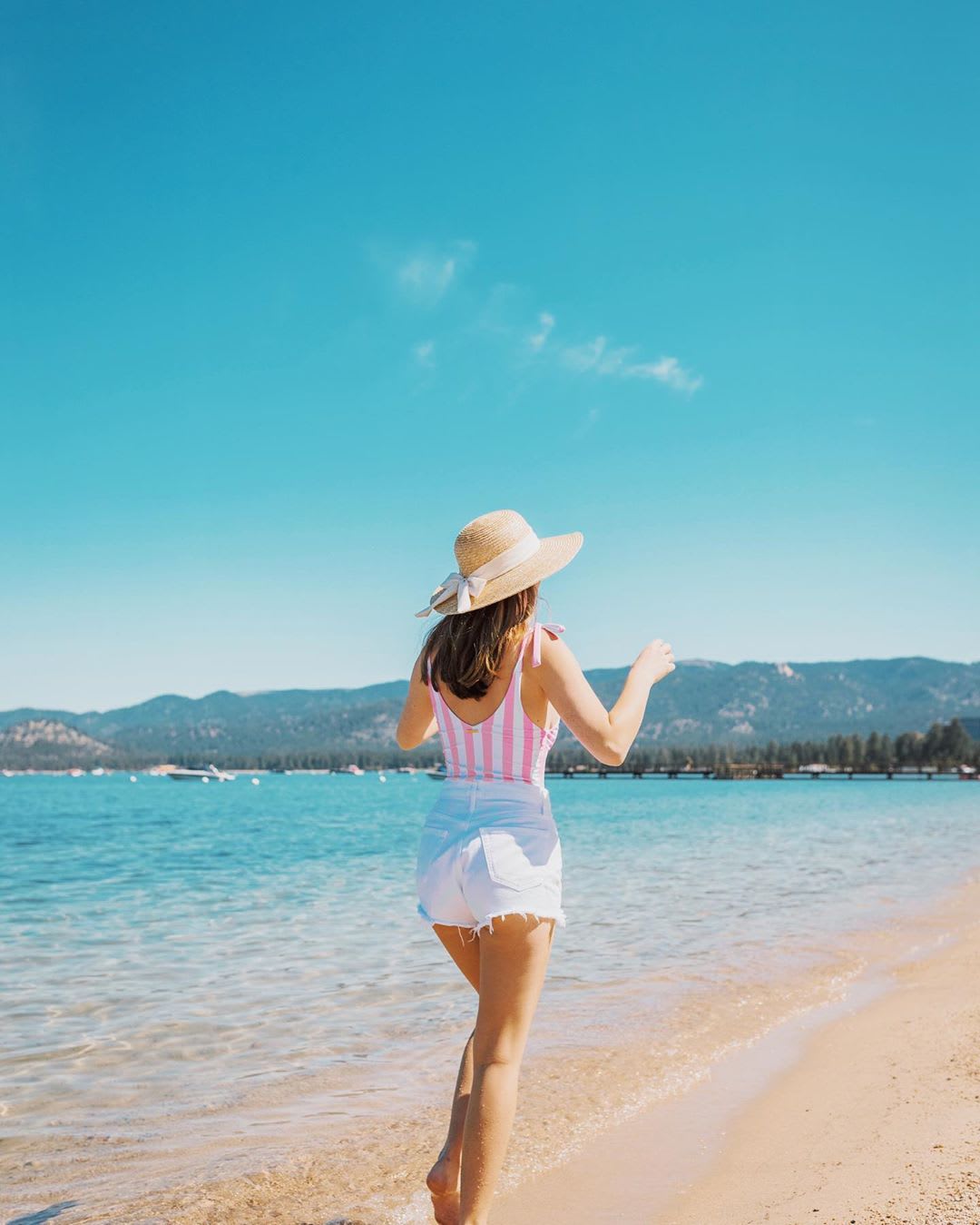 woman on a beach with a hat