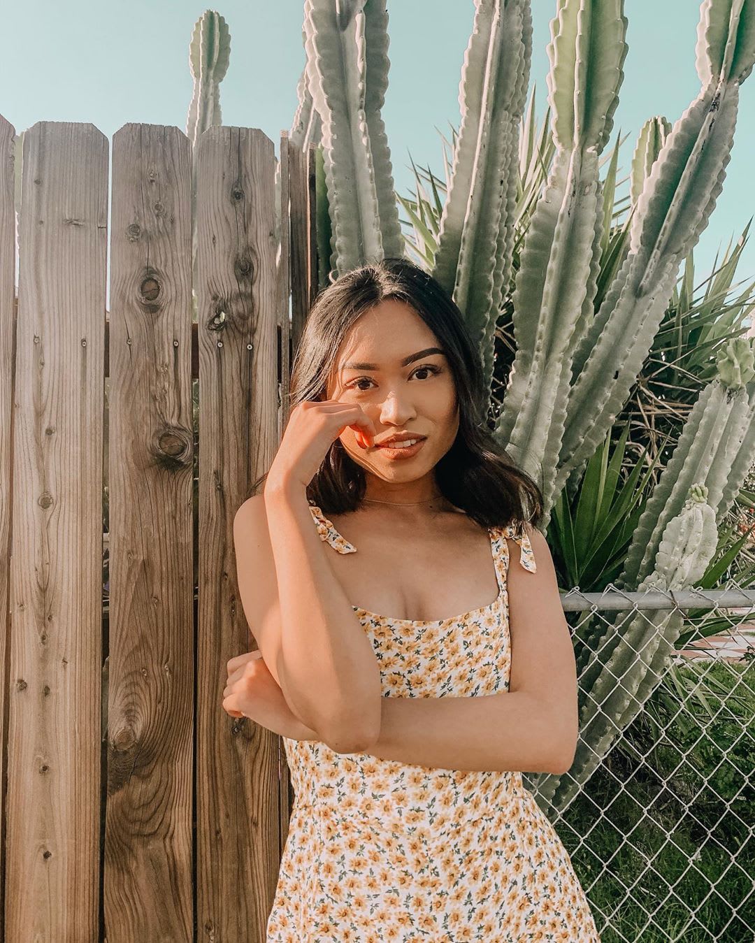 woman in front of cacti in floral jumpsuit