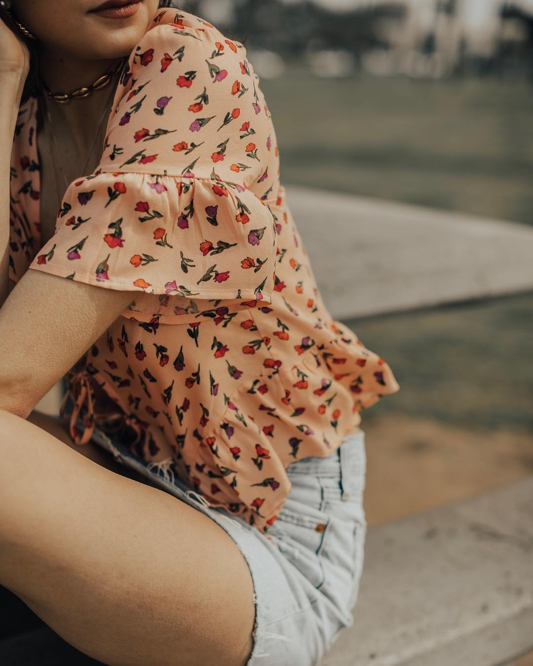 a woman sitting on the sidewalk