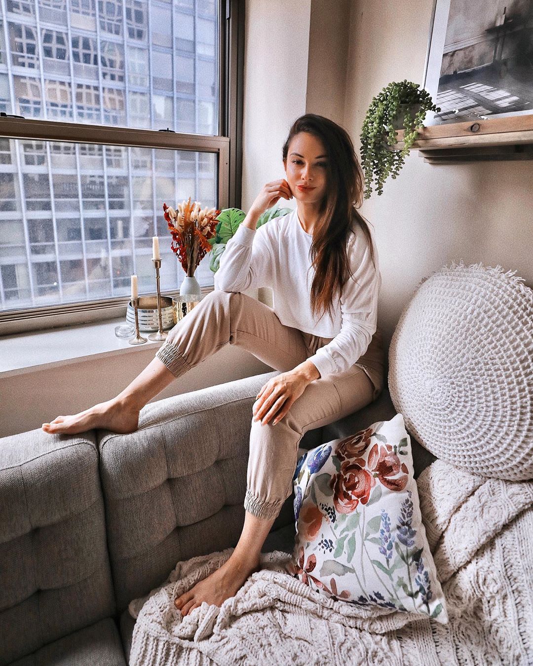 woman sitting on the couch inside for staycation