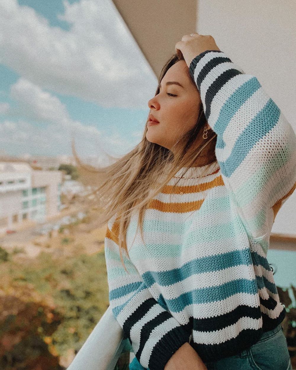 a woman looking off a balcony