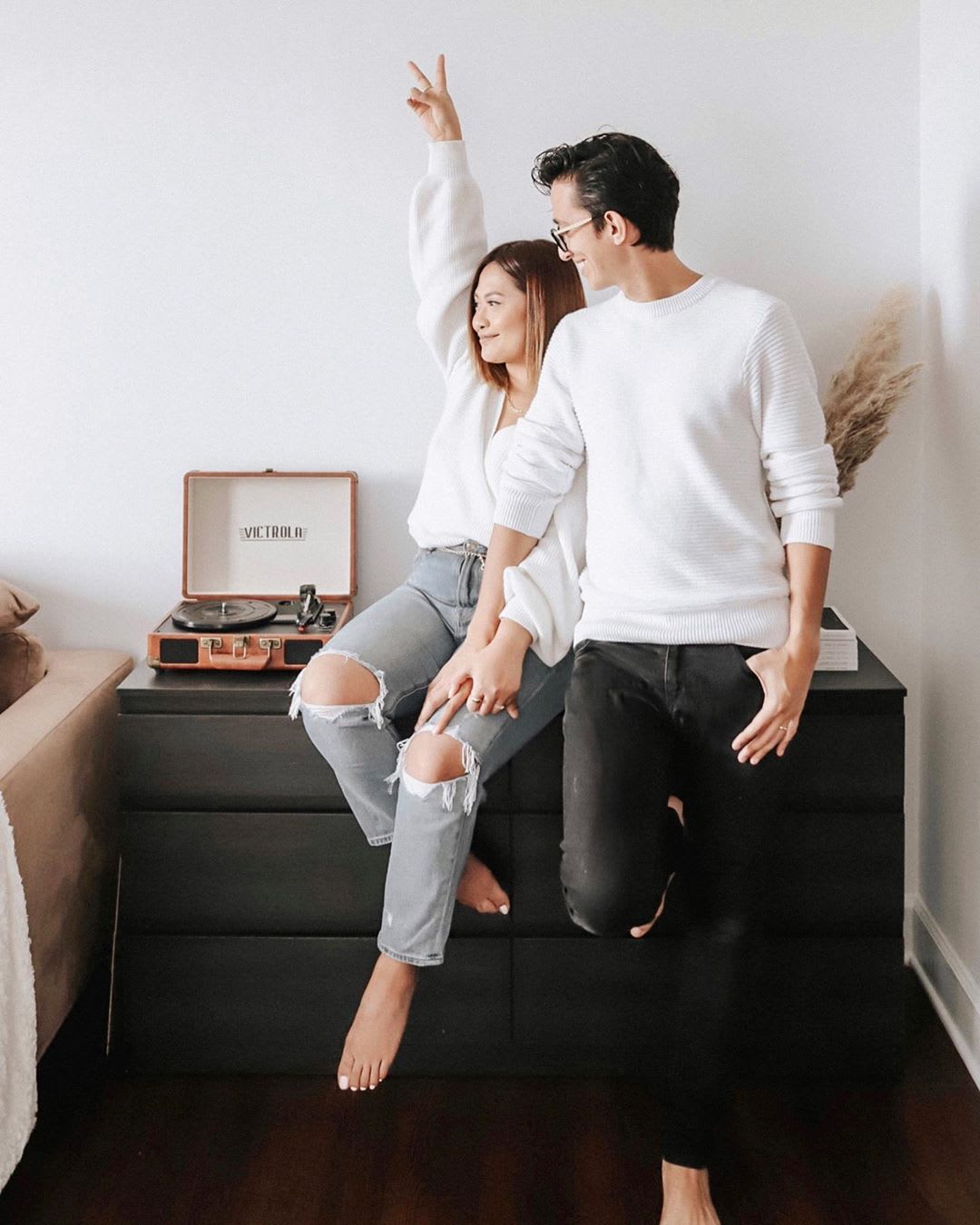 couple sitting at home listening to playlist