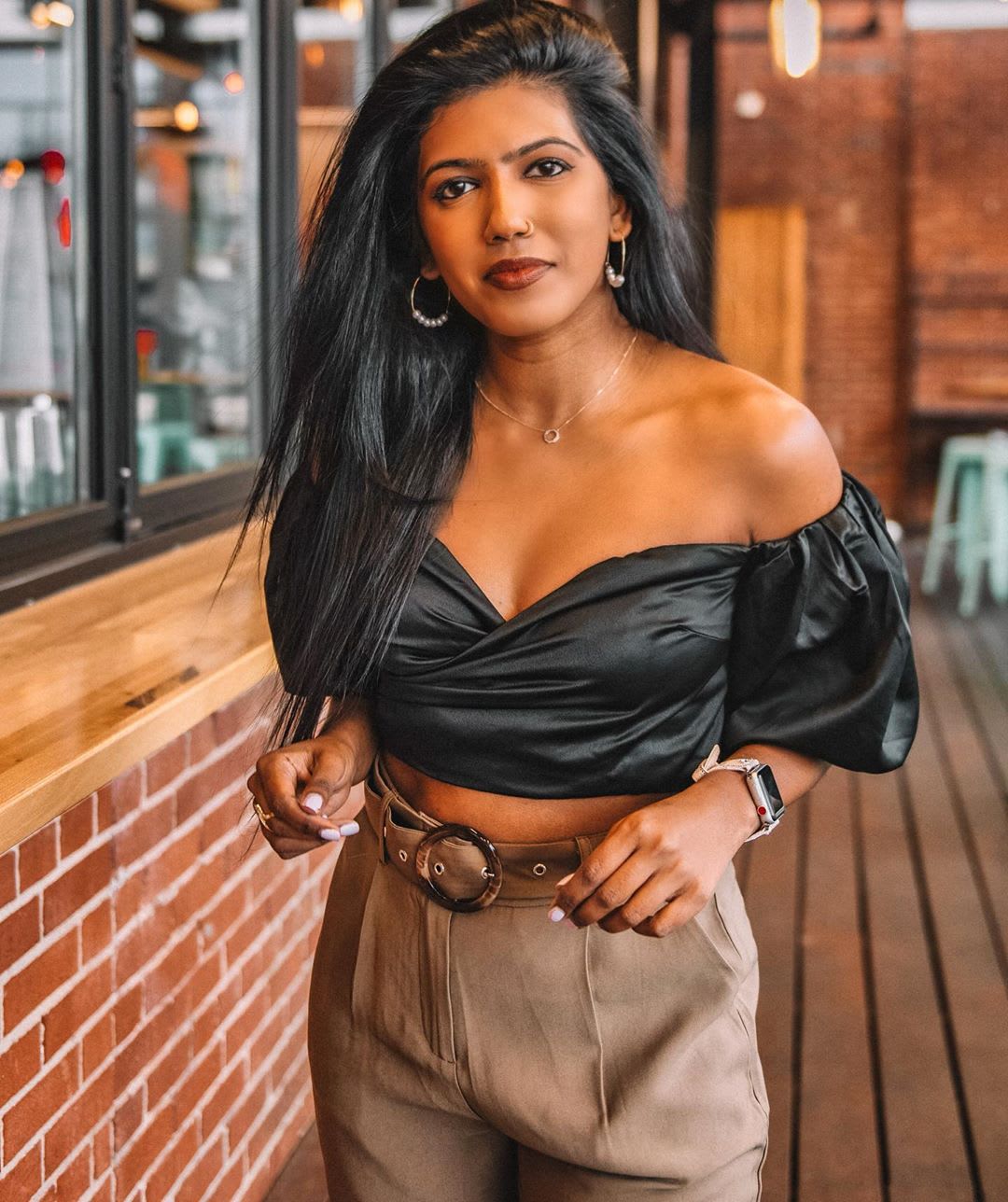 woman with off the shoulder top and dark hair blown out