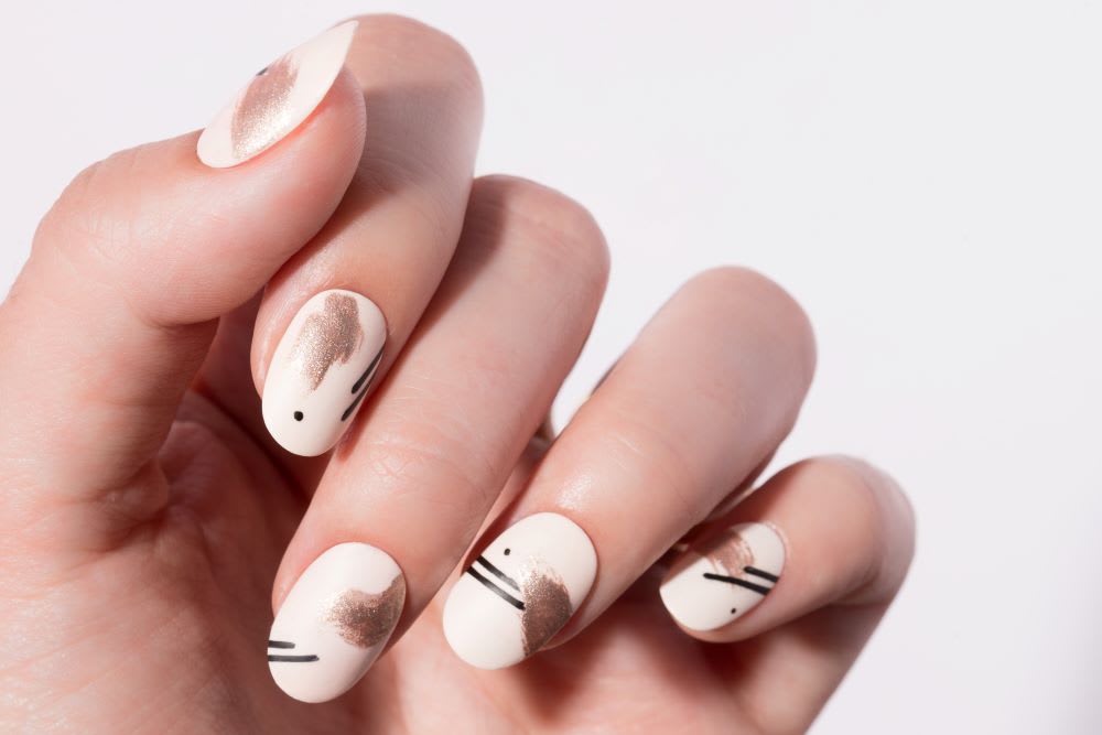 abstract nails with rose gold and black dots and stripes