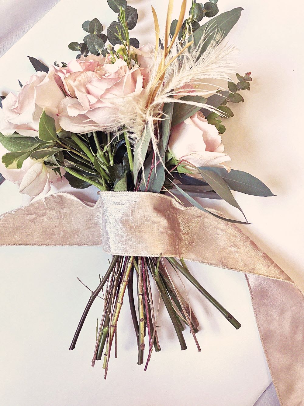 wrapping ribbon around bouquet