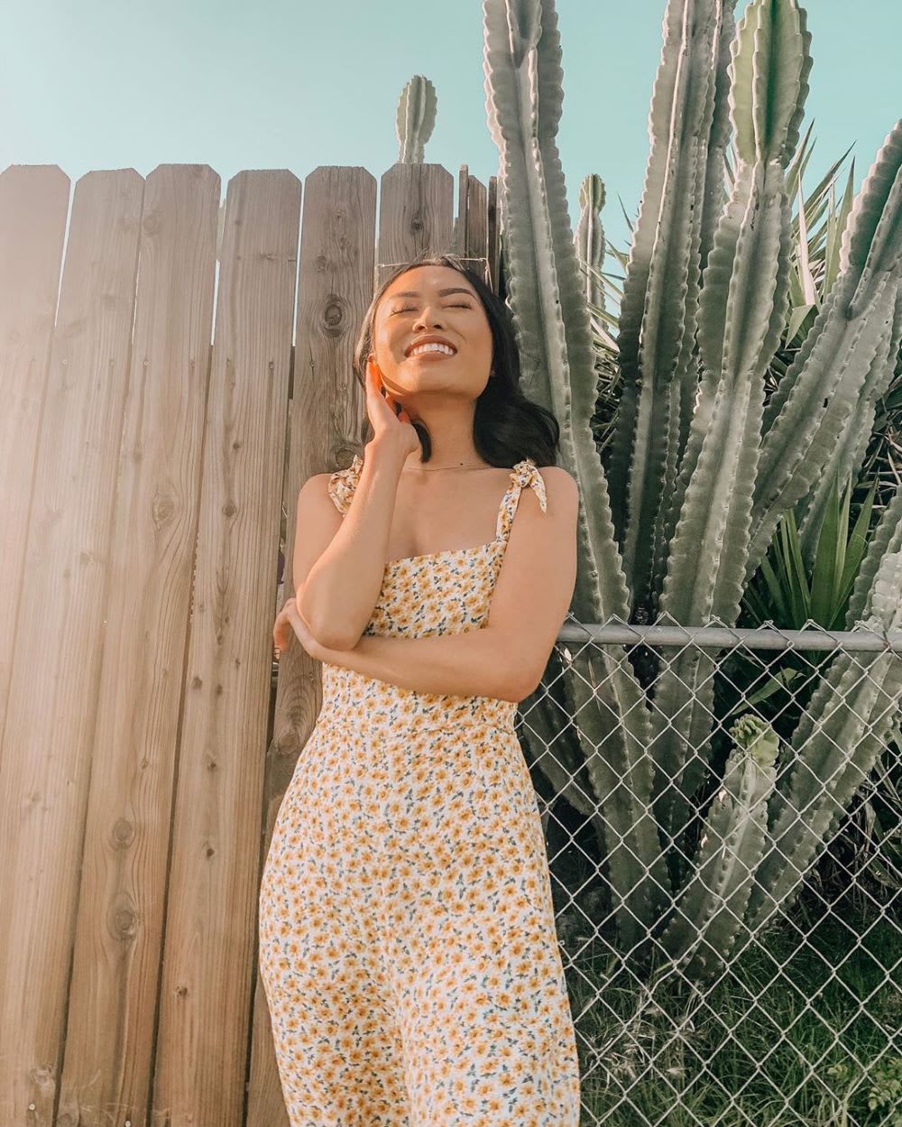 woman in summer sun wearing a floral jumpsuit