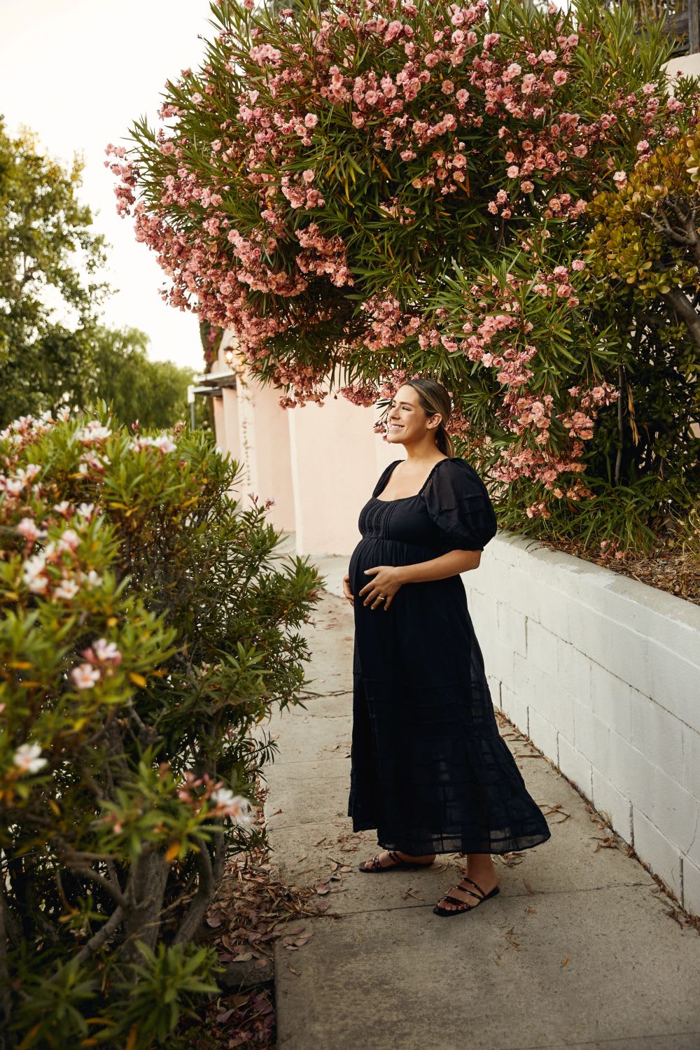 black puff sleeve dress on woman as summer pregnancy outfit