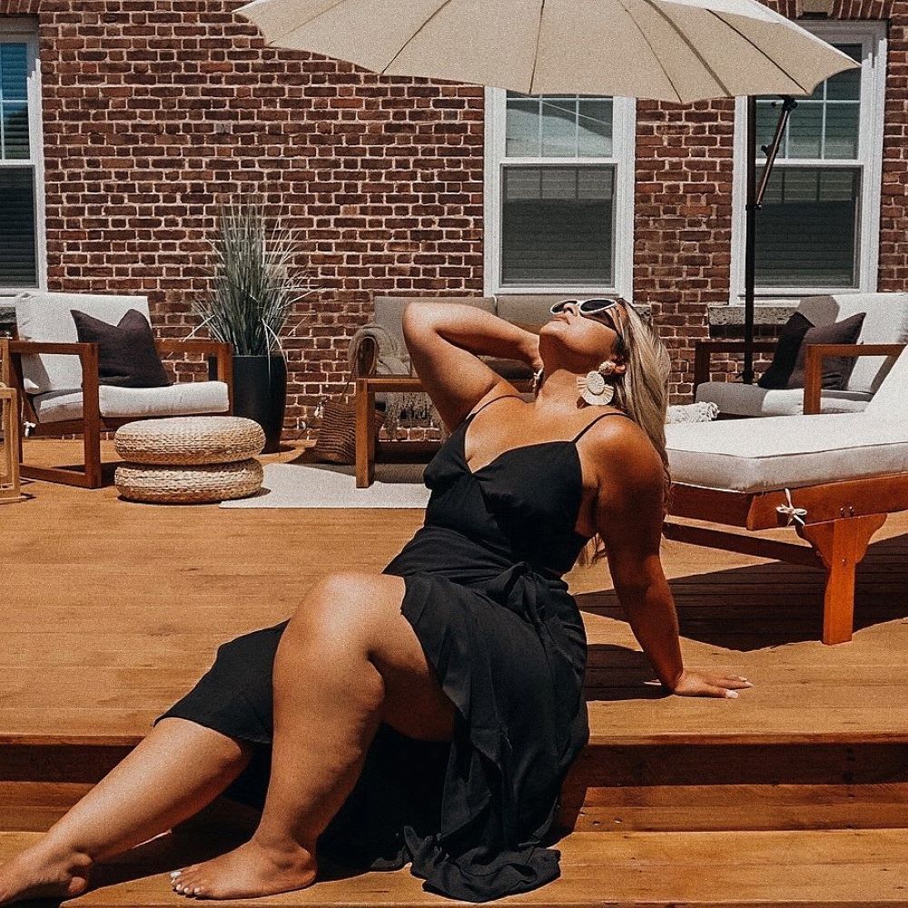 woman sunning herself in black sundress
