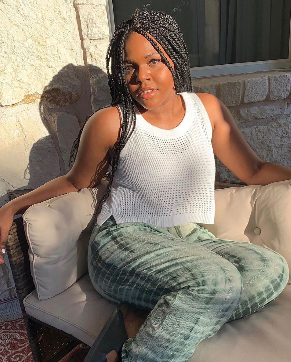 woman wearing tie dye pants and white top