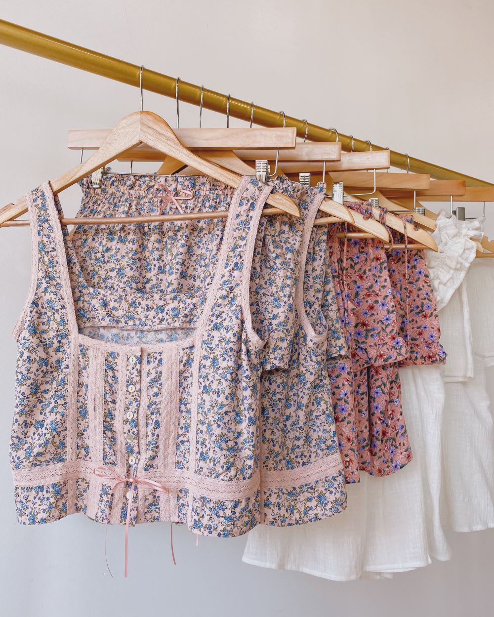 a rack of floral print pajamas hanging on hangers