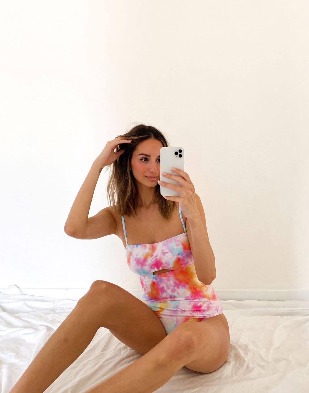woman in a tie dye swimsuit with cutout detail