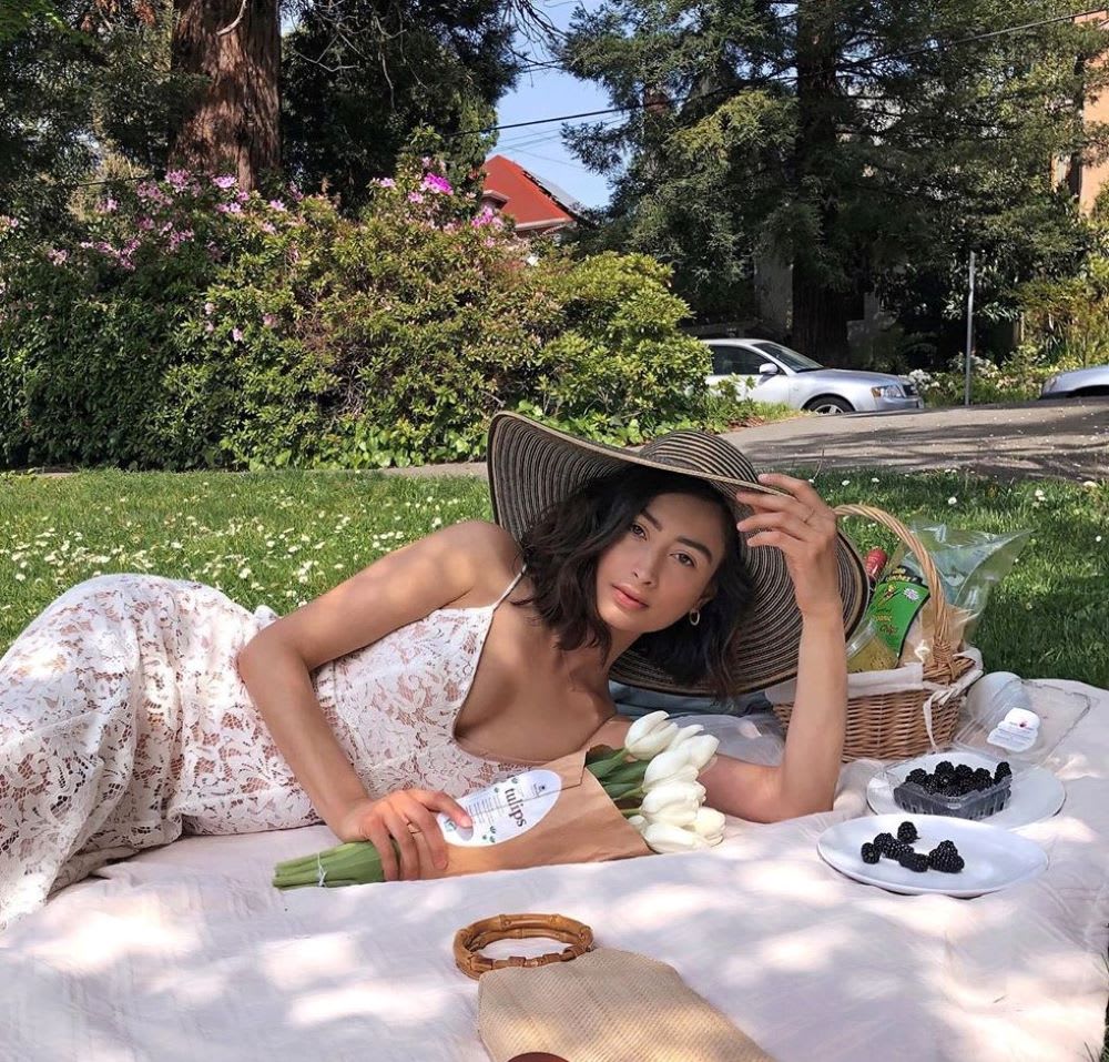 woman laying on a picnic blanket 