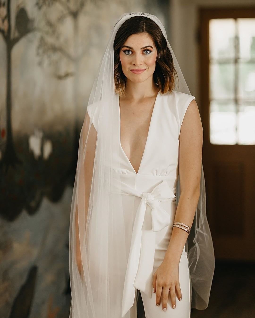 bride in a white jumpsuit for wedding